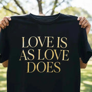 Love Is As Love Does Graphic T-Shirt - Black Cotton Tee with Gold Typography